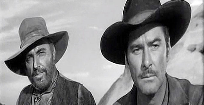 Howard Petrie as Cole Smith and Errol Flynn as Capt. Lafe Barstow, watching Indian trouble approach in Rocky Mountain (1950)