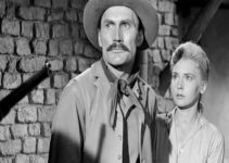 Jack Palance as Jacob Wade and Elaine Aiken as Ada, threatened by one of Jacob's former saddle mates in The Lonely Man (1957)