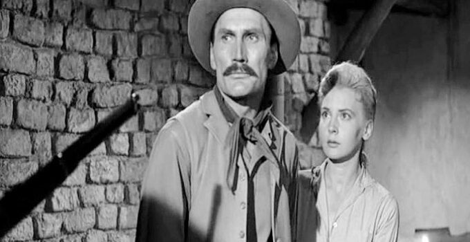 Jack Palance as Jacob Wade and Elaine Aiken as Ada, threatened by one of Jacob's former saddle mates in The Lonely Man (1957)