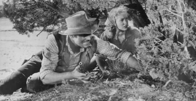 John Agar as Jeff Donner and Penny Edwards as Susan Crowley in Ride a Violent Miles (1957)