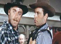 John Dehner as Emil Cabeau in a dispute with Bret Ivers (George Montgomery) as Larry Gallad (Jerome Courtland) looks on in Cripple Creek (1952)