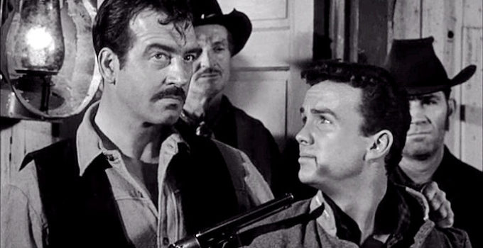 John Payne as John Willoughby with a gun on Gray Mason (Ben Cooper) in Rebel in Town (1956)