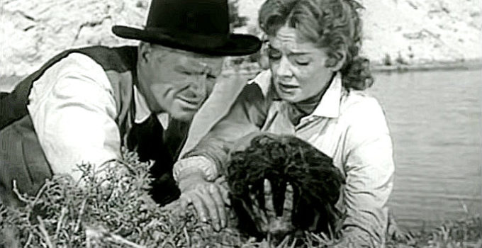 Louis Jean Heydt as Judge Ward Young and Julie Johnson (Arleen Wheelan) with her badly wounded husband in Raiders of Old California (1957)