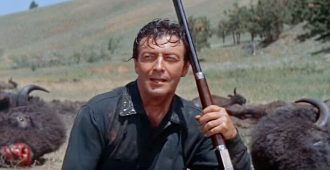 Robert Taylor as Charlie Gilson, resting among the carcasses of some of the buffalo he's killed in The Last Hunt (1956)