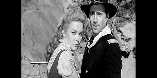 Patrice Wymore as Johanna Carter, casting an angry glance Barstow's way as he prepares to spring a trap on her fiance, Scott Forbes as Lt. Rickey in Rocky Mountain (1950)