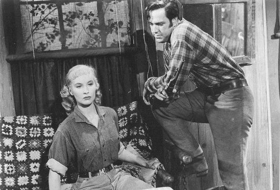 Penny Edwards as Susan Crowley, being questioned by Cpl. Norman (Bing Russell) in Ride a Violent Mile (1957)