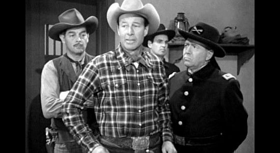 Ray Walker (right) as Col. Peterson, watching as Clyde Moss (Robert Lowery) and Mace Corbin (William 'Wild Bill' Elliott) recruit a trail crew in The Homesteaders (1953)
