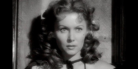 Rhonda Fleming as Candace Bronson, a woman trying to help the Confederacy the only way she can in The Redhead and the Cowboy (1951)