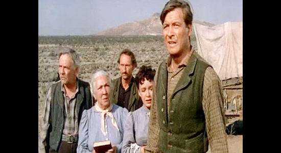 Richard Travis as Ben Johnson, objecting to leaving his young son half buried. Also pictured (from left) Griff Barnett as Papa Ludwig, Ilka Gruning as Mama Ludwig, Arthur Hunnicutt as Pop Brennan and Mary Anderson as Myra Johnson in Passage West (1951)