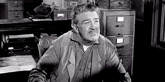 Robert Burton as Sheriff Travers, a man who sympathizes with Domino's quest in The Domino Kid (1957)