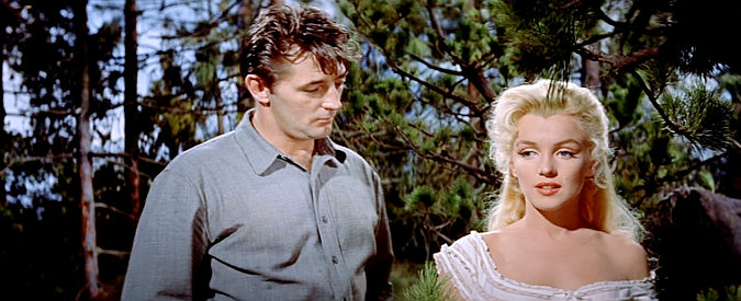 Robert Mitchum as Matt Calder and Kay (Marilyn Monroe) discuss what happens in Council City in River of No Return (1954)