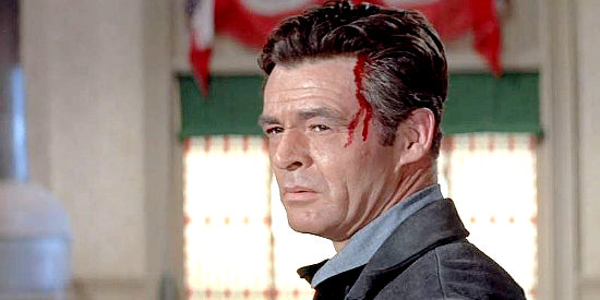 Robert Ryan as Cass Silver, showing the effects of a fight with one of Barrett's men in The Proud Ones (1956)