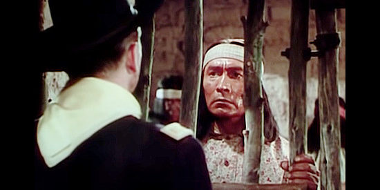 Ronald Reagan as Capt. Vance Britten meets with an imprisioned Geronimo (John War Eagle) in The Last Outpost (1951)
