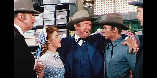 Roy Roberts as Pat Roberts, trying to fool two railroad detectives by greeting daughter Carrie (Beverly Tyler) as the fiance of a man named Adams (Audie Murphy) in The Cimarron Kid (1952)