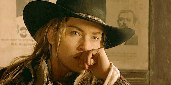 Sharon Stone as Ellen, wondering who's signing up for the six-gun contest in The Quiick and the Dead (1995)