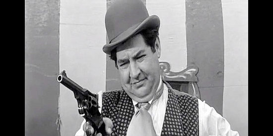 Stanley Adams as Professor Dudley, a traveling salesman showing off a new-fangled pistol in Black Patch (1957)