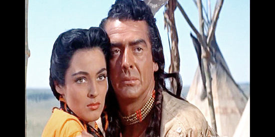 Suzan Ball as Black Shawl and Victor Mature as Crazy Horse, wondering about the approach of a cavalry scout in Chief Crazy Horse (1955)