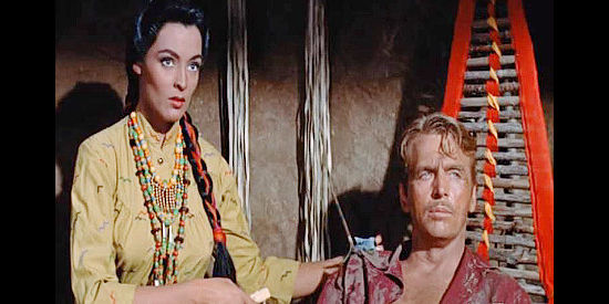 Suzan Ball as Little Fawn, taking care of the wounded white man Twist (John Lund) in Chief Crazy Horse (1955)