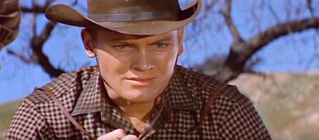 Tab Hunter as Trace Jordan, finding his brother dead and vowing vengeance in The Burning Hills (1956)