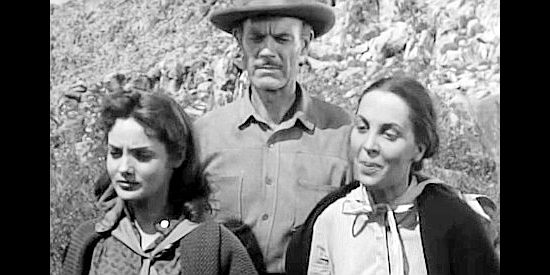 The Hemp family -- Charity (Mary Ellen Kay), Charlie (Paul McGuire) and his wife (Elizabeth Harrower) questioning why the patrol needs to take along a man near death in Thunder Pass (1954)