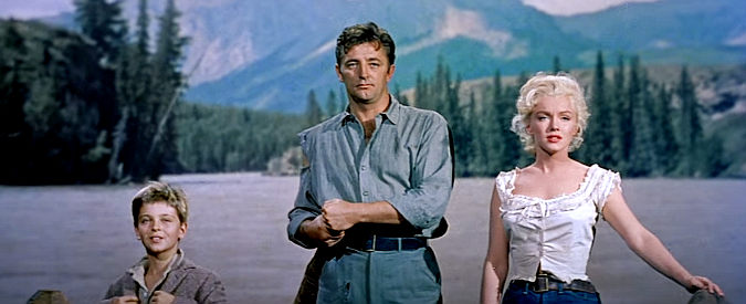 Traveling companions Mark Calder (Tommy Retig), Matt Calder (Robert Mitchum) and Kay (Marilyn Monroe) approach Council City by raft in River of No Return (1954)