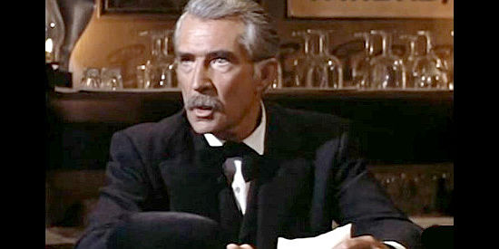 Trevor Bardette as Judge Rawlins, presiding of the trial of Jed Givens for a woman's murder in The Saga of Hemp Brown (1958)