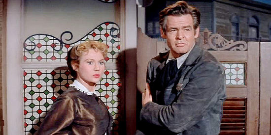 Virginia Mayo as Sally and Robert Ryan as Cass Silver, watching a final showdown in The Proud Ones (1956)