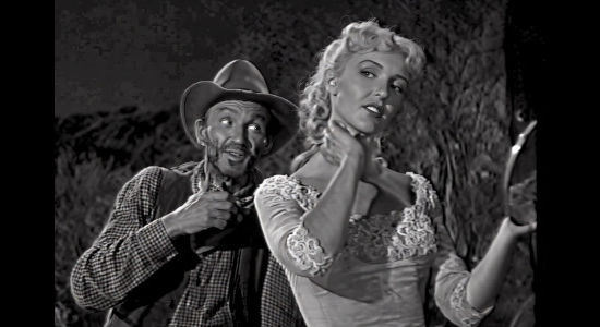 WIlliam Fawcett as Alkali watching Queenie Hart (Maria Hart) pretty herself up to impress Bill Foster in Cattle Queen (1951)