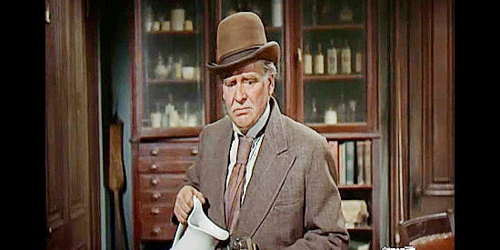 Wallace Ford as Doc Curtis, wondering if he can get in trouble for lying about a sheriff's death in Destry (1954)