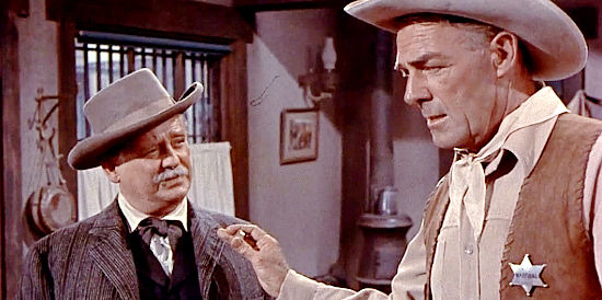 Wallace Ford as Dr. Amos Wynn, issuing an unwelcome warning to Calem Ware (Randolph Scott) in A Lawless Street (1955)