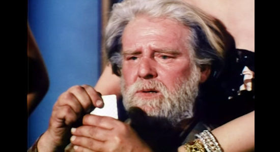 Wallace Ford as dynamite man Elias Hobbs, enjoying luck at cards and the company of a pretty woman in The Great Jesse James Raid (1953)