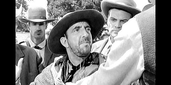 Wally Vernon as OK, Okay, a member of Whitey Turner's gang, being taken into custody in Fury at Gunsight Pass (1956)