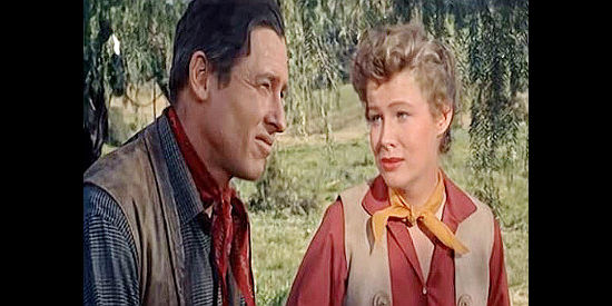 Will Rogers Jr. as Sheriff Tom Brewster and Nancy Olson as Katie Brannigan, discussing the investigation into her dad's death in The Boy from Oklahoma (1954)