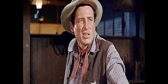 Will Rogers Jr. as Tom Brewster, a man who stops in Bluerock to mail his application for a law degree and winds up becoming sheriff in The Boy from Oklahoma (1954)