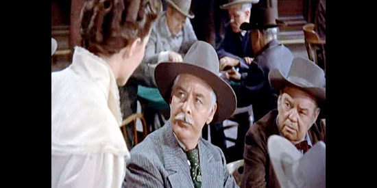 William Johnstone as Col. Flynn, ignoring warnings that his gambling hall is a target for the Malady gang in Riding Shotgun (1954)