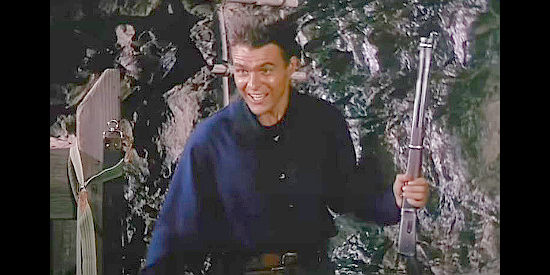 William Reynolds as Will Dalton, excited that a gang member believed dead has showed up alive and well in The Cimarron Kid (1952)