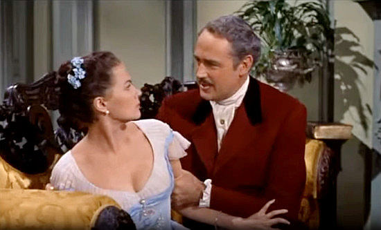 Yvonne De Carlo as Amantha Starr, trying to fend off the advances of Charles de Marigny (Patric Knowles) in Band of Angels (1957)