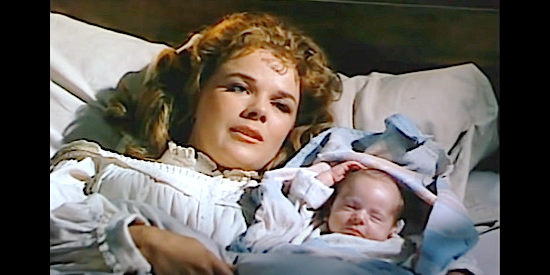 Sally Forrest as Lily Fasken with the baby that starts the trouble in Vengeance Valley (1951)