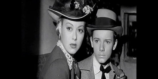 Adele Mara as Beth Martin and Peter Miles as her younger brother Tommy, startled by bandits who show up to rob the stagecoach in California Passage (1950)
