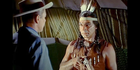 Anthony Caruso as Natchakoa, the chief's war-like son, checking Farrell's six-gun in Cattle Queen of Montana (1954)