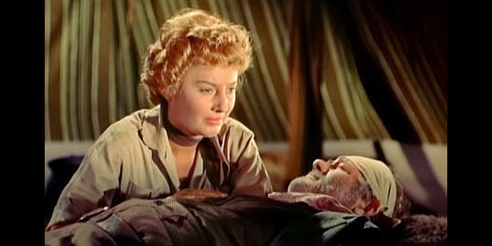 Barbara Stanwyck as Sierra Nevada Jones, fretting over a wounded Nat Collins in Cattle Queen of Montana (1954)