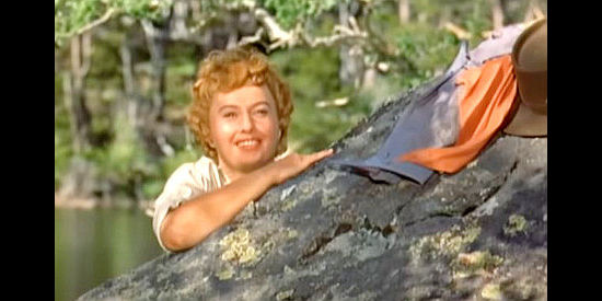 Barbara Stanwyck as Sierra Nevada Jones, reacting to Farrell catching her at the water hole in Cattle Queen of Montana (1954)