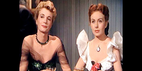 Carole Mathews as Cynthia London and Jeanne Crain as Linda Culligan, admiring Brett Stanton from afar in City of Bad Men (1953)