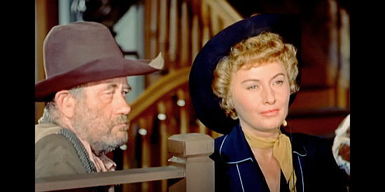 Chubby Johnson as Nat Collins and Barbara Stanwyck as Sierra Nevada Jones, trying unsuccessfully to file her late father's land claim in Cattle Queen of Montana (1954)