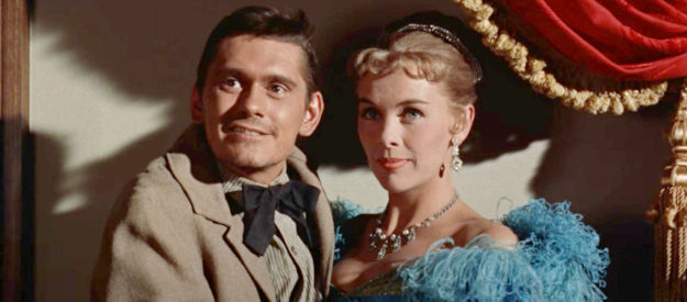 Dick York as Charlie, a Reese trail hand enjoying the company of a lovely lass (Bek Nelson) as a post-cattle drive party in Cowboy (1958)