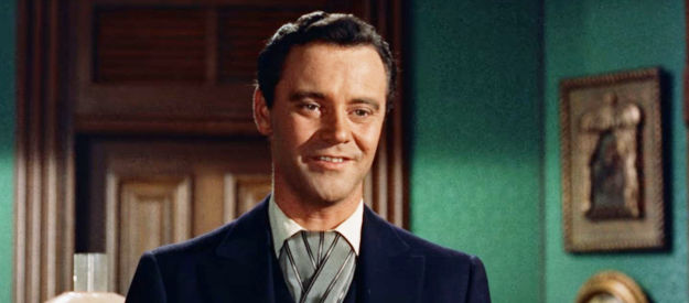 Jack Lemmon as Frank Harris, a hotel clerk in love with one of his guests, lovely Maria Vidal in Cowboy (1958)