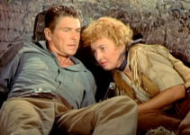 Ronald Reagan as Farrell and Barbara Stanwyck as Sierra Nevada Jones, taking cover from the Indians in Cattle Queen of Montana (1954)