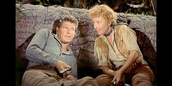 Ronald Reagan as Farrell and Barbara Stanwyck as Sierra Nevada Jones, preparing for an Indian attack in Cattle Queen of Montana (1954)