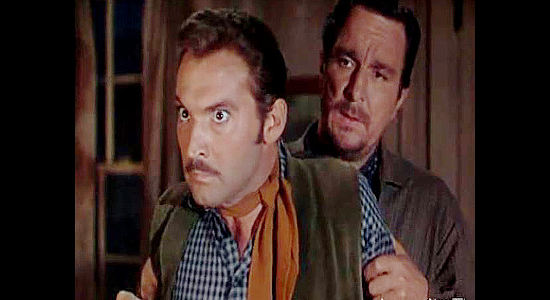 Zachary Scott as Jason Brett, held back by one of his men during a fit of anger with Sheriff Harris in Colt .45 (1950)