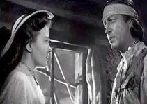 Paula Raymond as Orrie Masters trying to convince Lance Poole (Robert Taylor) to give up the fight in Devil's Doorway (1950)